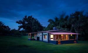 a tiny house in a field at night at SECRET IVORY in Masinagudi