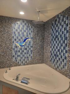 a bath tub in a bathroom with checkered tiles at Birch Tree Cabins in Homer +5 photos