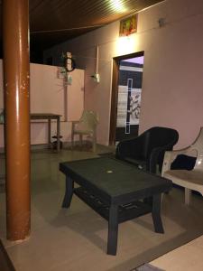 a room with a table and chairs and a pole at Gokarna Ocean Tree in Gokarna
