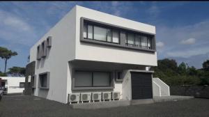 a white house with windows on the side of it at Welcome Pico in Madalena +14 photos