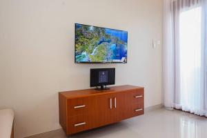 a television on top of a wooden dresser in a room at Villa Maha IV in Dalung