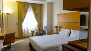 Llit o llits en una habitació de Hotel Hilen De Ville