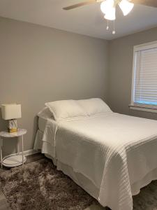 Un dormitorio con una cama y un ventilador de techo. en Beach Block, 4 mi to AC, en Brigantine
