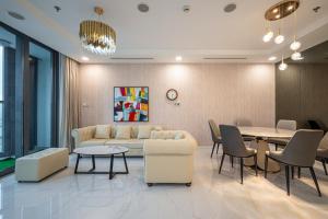 a living room with a couch and a table at LANMARK 81 Enigma Residences in Ho Chi Minh City