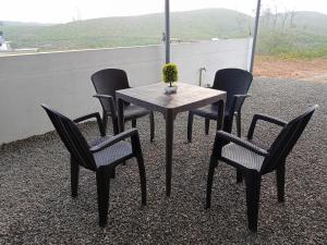 a table and chairs with a vase on a roof at The Celeste Inn Vagamon in Vagamon