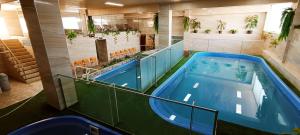 a swimming pool in a large room with a swimming pool at HGA-Perla-Spa in La Paz