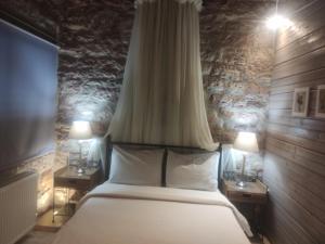 a bedroom with a large bed with two night stands at Petrino Rodo in Karpenision