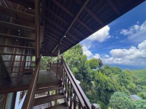 a balcony with a view of the forest at Munduk Tjeraki House in Munduk +35 photos