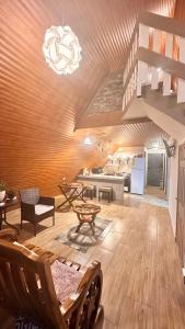 a large living room with a table and a kitchen at Casa María in Siguatepeque