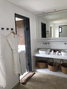 a bathroom with two sinks and a large mirror at Villa Calypso in Bel Ombre