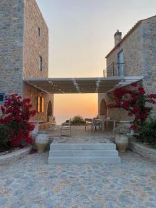 a patio with a table and a patio umbrella at Elemani Villas in Areopolis
