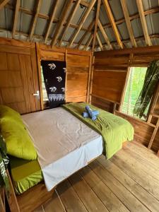 a bed in the middle of a room at Tetebatu Jungle Vibes in Tetebatu