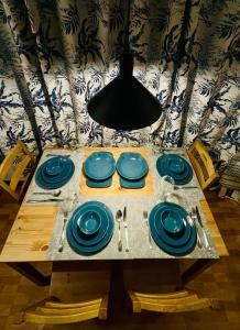 a table with blue plates and utensils on it at 2 Bedroom Condo in the center of MM in Manila