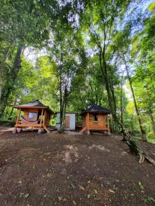 a cabin and a playground in the woods at Tetebatu Jungle Vibes in Tetebatu