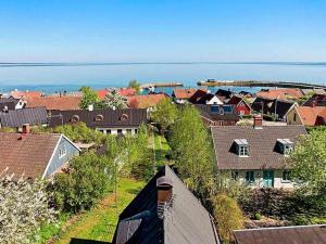 an aerial view of a town with houses and the ocean at 4 person holiday home in KIVIK in Kivik