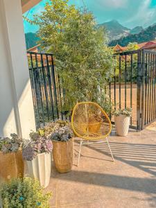 a yellow chair sitting on a porch with potted plants at TRaiOn House - Villa nguyên căn và Homestay in Mộc Châu