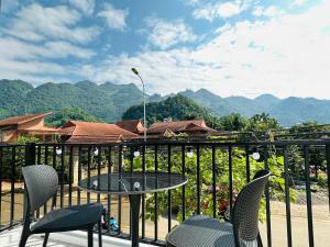 a patio with chairs and a table on a balcony at TRaiOn House - Villa nguyên căn và Homestay in Mộc Châu