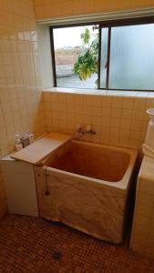 a bath tub in a bathroom with a window at River Side izumi in Chōjamachi +31 photos