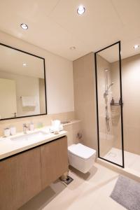 a bathroom with a sink and a toilet and a shower at Burj Crown 2BR Apartment with Panoramic Burj Khalifa View in Dubai