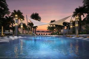 uma grande piscina com palmeiras e um pôr-do-sol em 59th Floor Infinity Pool, Luxury 5 Star Room em Praia de Jomtien