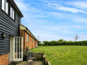 a patio of a house with a lawn at 3 Hazlewood in Aldringham