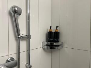 a shower stall with two bottles of shampoo at Studio Haus Castello in Randa