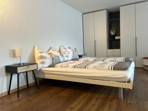 a bedroom with a bed with a night stand and a table at Studio Haus Castello in Randa