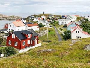 a small town with a red house on a hill at Holiday home Vikholmen 