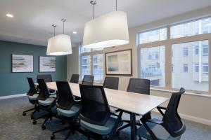 a conference room with a long table and chairs at Waltham 2br w gym wd near restaurants BOS-970 in Waltham