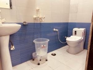 a small bathroom with a toilet and a sink at The Lord Krishna Residency Vrindavan in Vrindāvan