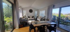 a woman standing in a living room with a table at Cambridge Retreat in Cambridge