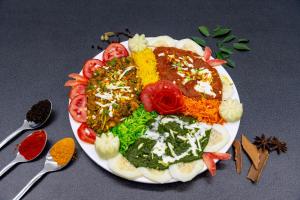 a plate of food with different types of food at Hotel Darshan Executive in Tuljapur