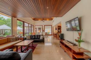 a living room with a couch and a table at Villa Dorado - Steps from Jimbaran Beach in Jimbaran