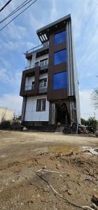 a tall building sitting in the middle of a parking lot at The Lord Krishna Residency Vrindavan in Vrindāvan