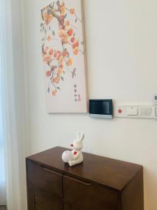 a small white bunny sitting on top of a wooden cabinet at 【森林城市高尔夫别墅】高性价比，双层别墅民宿 in Gelang Patah