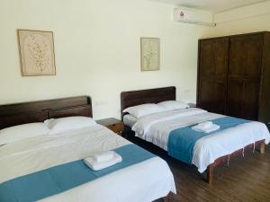 a room with two beds with towels on them at 【森林城市高尔夫别墅】高性价比，双层别墅民宿 in Gelang Patah