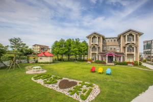 a large house with a playground in the yard at 伊莎愛莉溜滑梯親子民宿 in Wujie