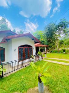 a house with a green lawn in front of it at Green willa in Badulla