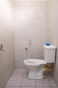 a bathroom with a toilet in a room at Beach Box Dimash Apartments in Mombasa