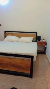 a bedroom with a bed and two night stands at Appart boa in Cotonou