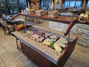 a display case with food in a restaurant at Aktiv Hotel Winterberg in Winterberg