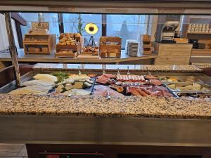 a buffet with meats and other foods on display at Aktiv Hotel Winterberg in Winterberg