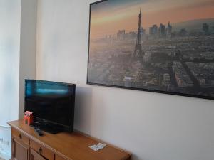 a flat screen tv sitting on top of a dresser at Apartment Villa Nähe Bahnhof in Heide