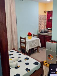 a kitchen with a table and a kitchen with a table and chairs at RÉSIDENCE DES 7 COLLINES in Yaoundé