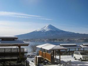 a snow covered mountain in the distance with a snow covered building at Lake Kawaguchi Rental Villa Tozawa Center - Vacation STAY 46658v in Oishi