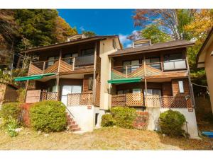 an apartment building with balconies and bushes at Lake Kawaguchi Rental Villa Tozawa Center - Vacation STAY 46845v in Oishi