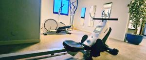 a room with a gym with an exercise machine at Appart'hôtel Goélia Sun City in Montpellier