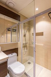 a bathroom with a shower and a toilet at 14DC Tambuli Seaside Living in Lapu Lapu City