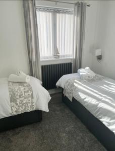 a bedroom with two beds next to a window at Captains Quarters in Charlestown