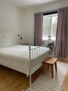 a bedroom with a white bed and a window at Nära fjäll och natur! in Vemhån